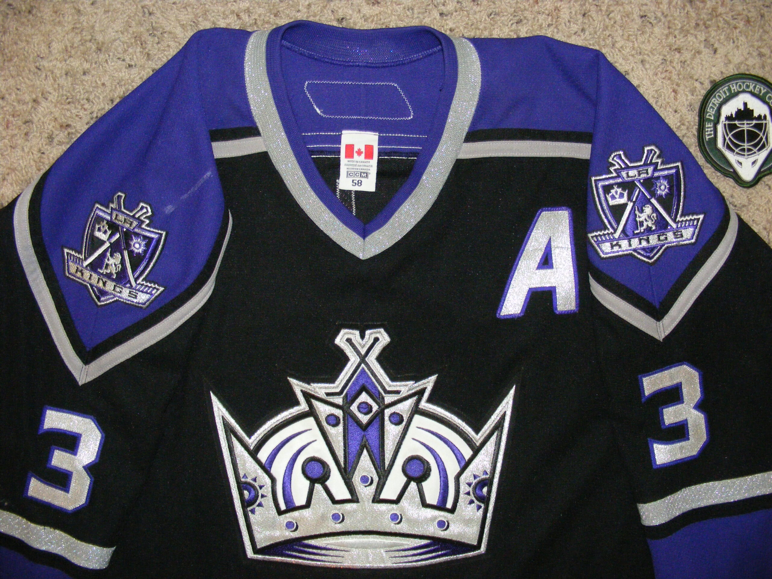 GAME WORN LA KINGS WHITE AND PURPLE JERSEY LEWIS